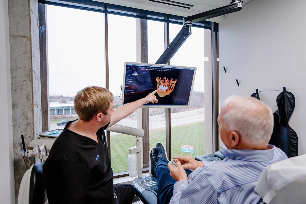Dr. Bill Keith showing a patient a 3D scan of teeth at Keith Associates Dental Implant Center in Mission, KS.